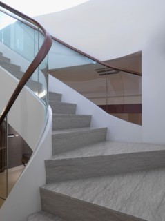 View midway up modern staircase with glass railing