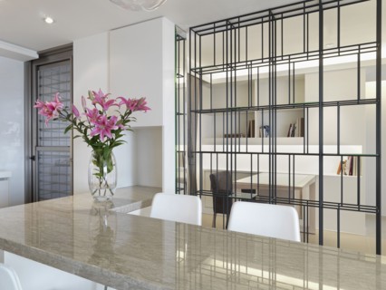 Kitchen counter with breakfast bar and vase of flowers