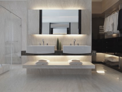 Master bathroom with double sinks and closet space