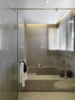Large bathtub behind glass wall and door