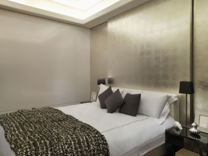 Modern bedroom with gold wall