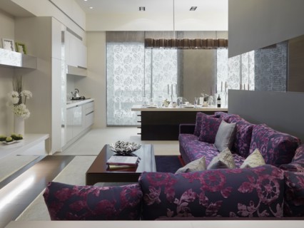 Modern purple sofa outside kitchen