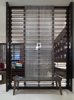 Decorative room dividing wall with bench