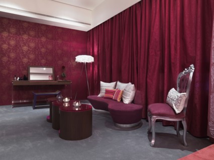 Chic bedroom with pink glass coffee table and grey carpet