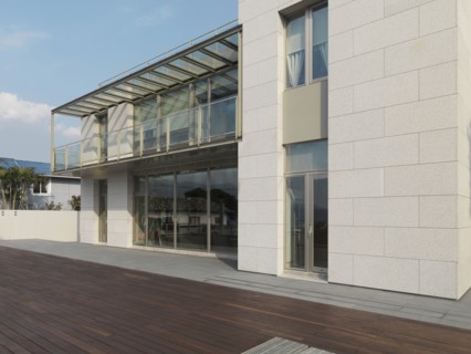 Patio out back of modern multiple story home