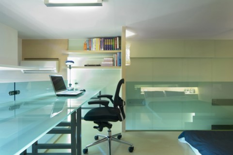 Desk and office chair in bedroom of modern home