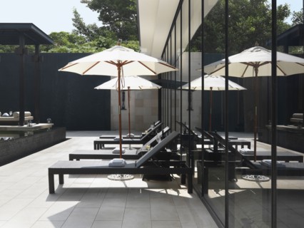 Lounge chairs and umbrellas by pool
