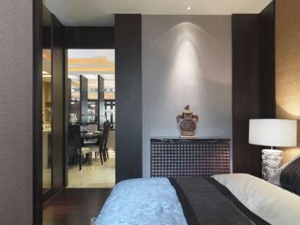 Bed and doorway in modern bedroom