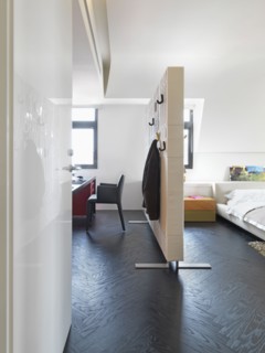 Room partition separating bedroom and office in modern home