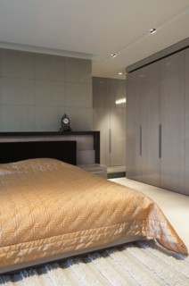 Coral comforter on bed in modern bedroom