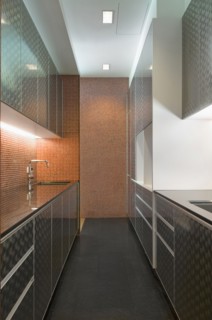 Modern kitchen with cabinets and mosaic tile wall