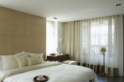 Light colored pillows and comforter on bed