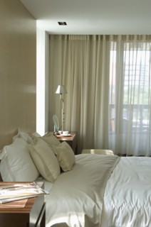 Light colored pillows and comforter on bed