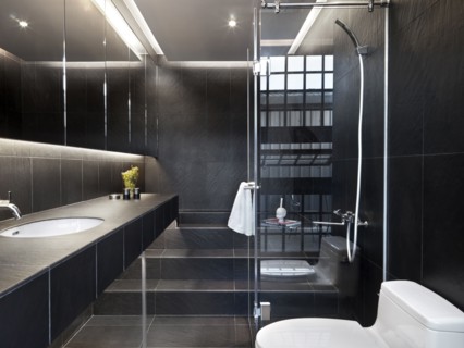 Black tile modern bathroom with glass shower