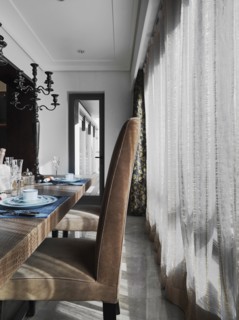 Detail of high back chair at dining table