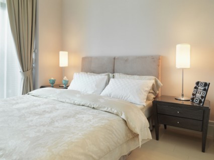 Light colored bed in modern bedroom