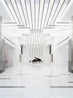 Baby grand piano in bright white room