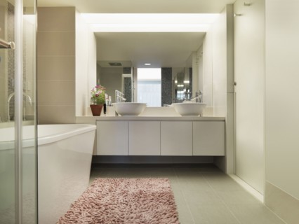 Light colored modern bathroom with large bathtub