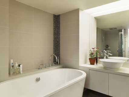 Light colored modern bathroom with large bathtub