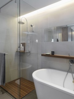 Small glass shower in corner of modern bathroom