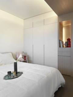 Serving tray on end of white bed