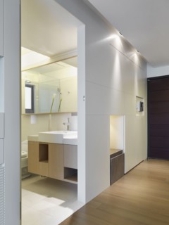 Hallway and doorway leading to modern bathroom