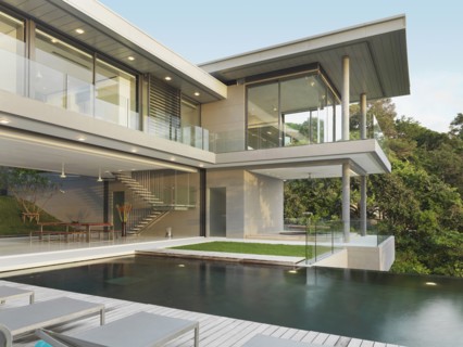 Multiple story modern home with swimming pool out front