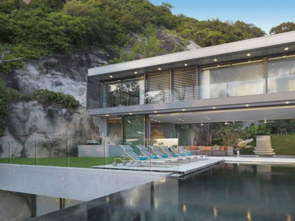 Multiple story modern home with swimming pool out front