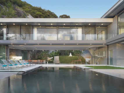 Multiple story modern home with swimming pool out front