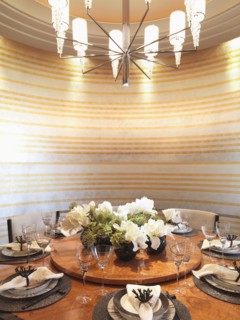 Circular dining table and striped wall paper in modern dining room
