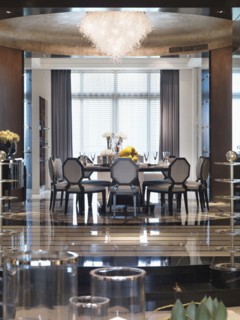 Elegant circular dining table beneath chandelier