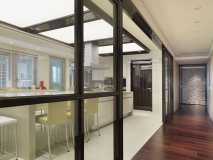 Hardwood hallway along kitchen with pocket glass doors
