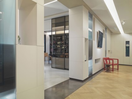 Red chair in hallway of modern home
