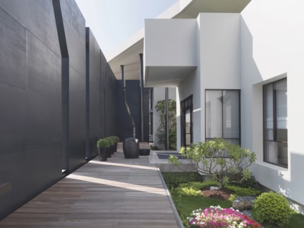 Wooden walkway along side of modern home