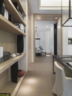 Hallway through modern home with bookcase