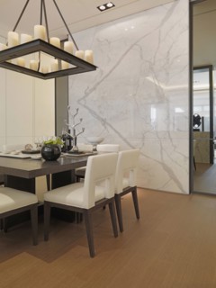 Black and white dining table in dining room with marble wall