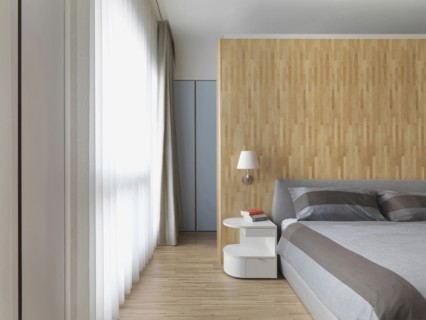 Hardwood floor and wall in modern bedroom