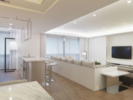 Modern living room with white sectional sofa and bar