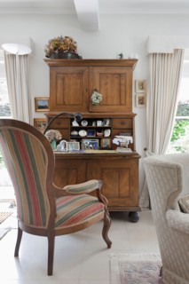 Striped armchair at wooden desk in traditional living room