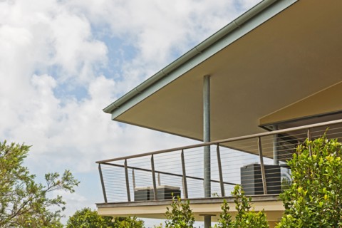 Balcony of residential building against cloudy sky