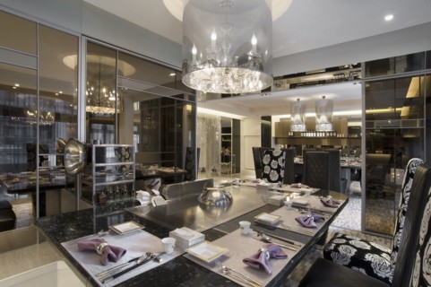 Chandelier above elegant dining table in hotel restaurant