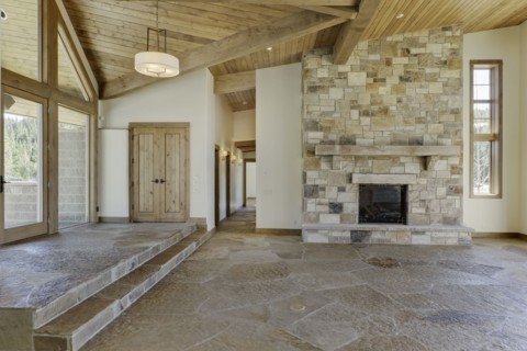 Empty interior with large stone fireplace