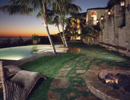 Backyard of modern home with pool at sunset