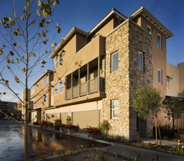 Rear of contemporary townhomes and garages