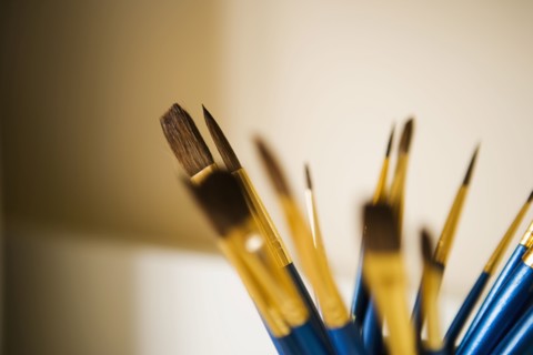 Blue and Gold Paintbrushes in a Jar