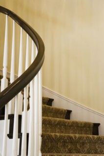 Contemporary Stairway with White Railings and Dark Wood Bannister