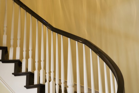 Contemporary Stairway with White Railings and Dark Wood Bannister
