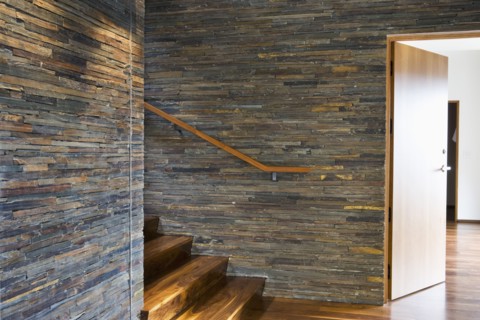 Hardwood Staircase with Stone Tile Walls