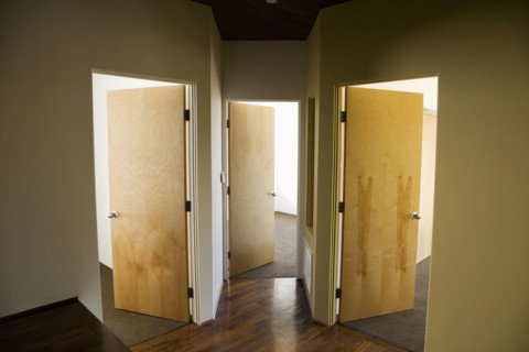 Three Open Doors in Modern Hallway