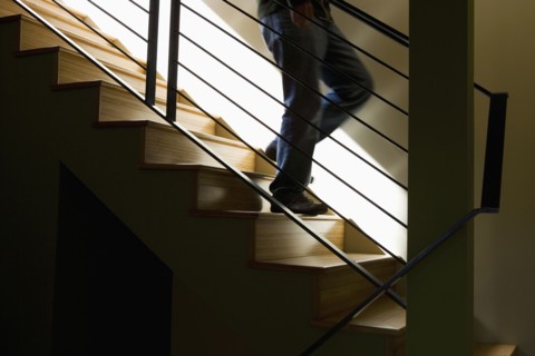 Moody Detail of Person Descending Modern Stairs